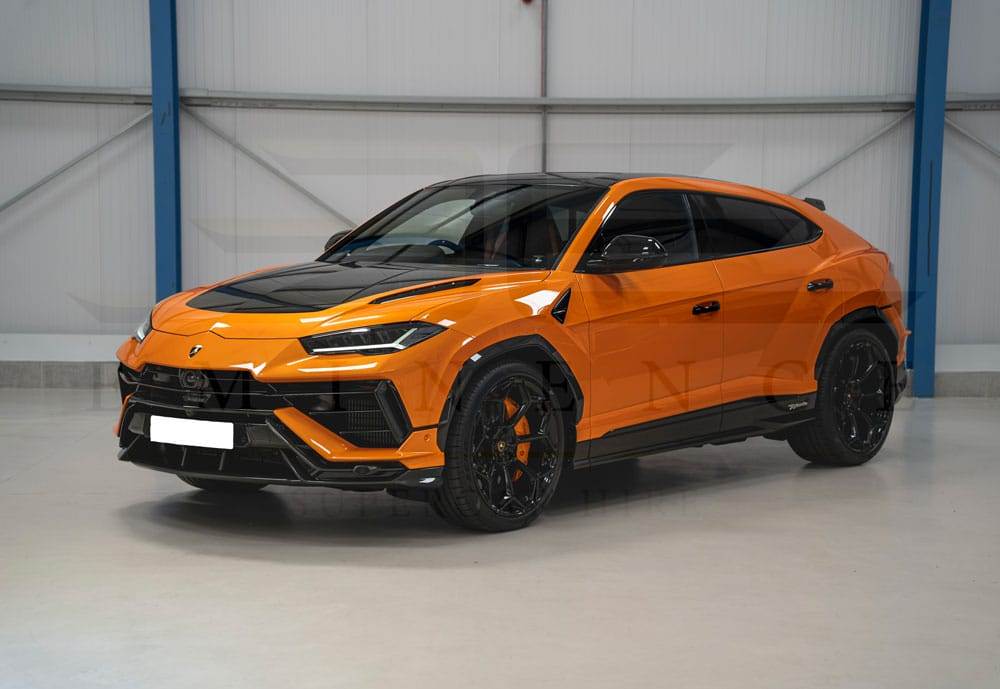 An orange and black luxury SUV, available for hire, is parked in an indoor garage with a concrete floor and metal walls. The vehicle boasts a modern, sleek design with tinted windows and black wheels.